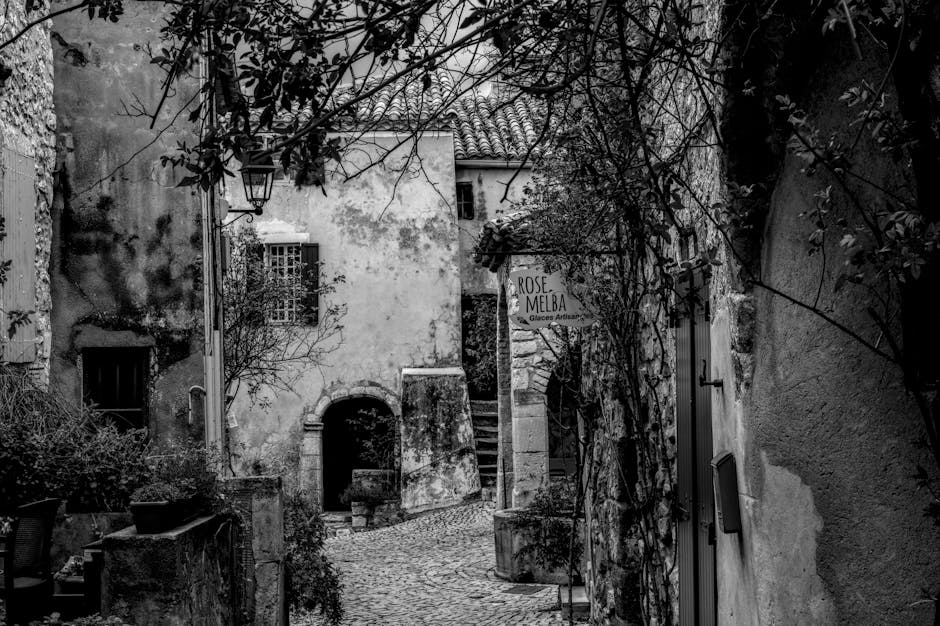 Schwarz-weißes Kopfsteinpflaster in Matera zwischen verwitterten Mauern und Schildern