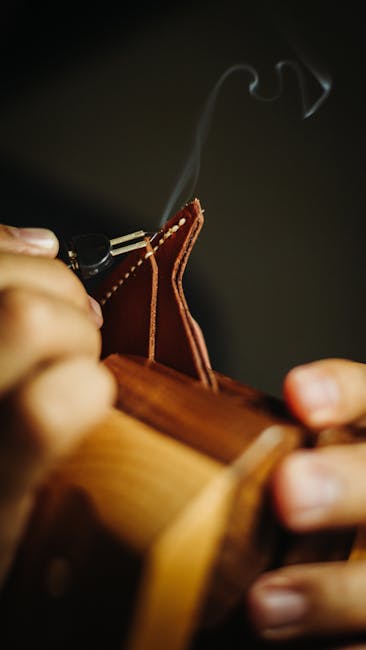 Close-up of artisan burnishing leather edges in a Matera workshop