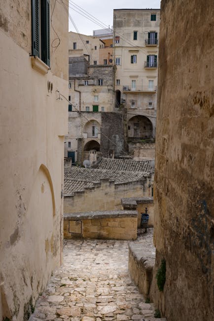 Stone steps descending through Matera's historic Sassi cave dwellings and buildings