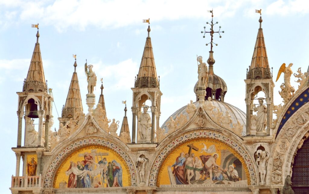 Golden mosaics and spires adorning St. Mark's Basilica facade in Venice