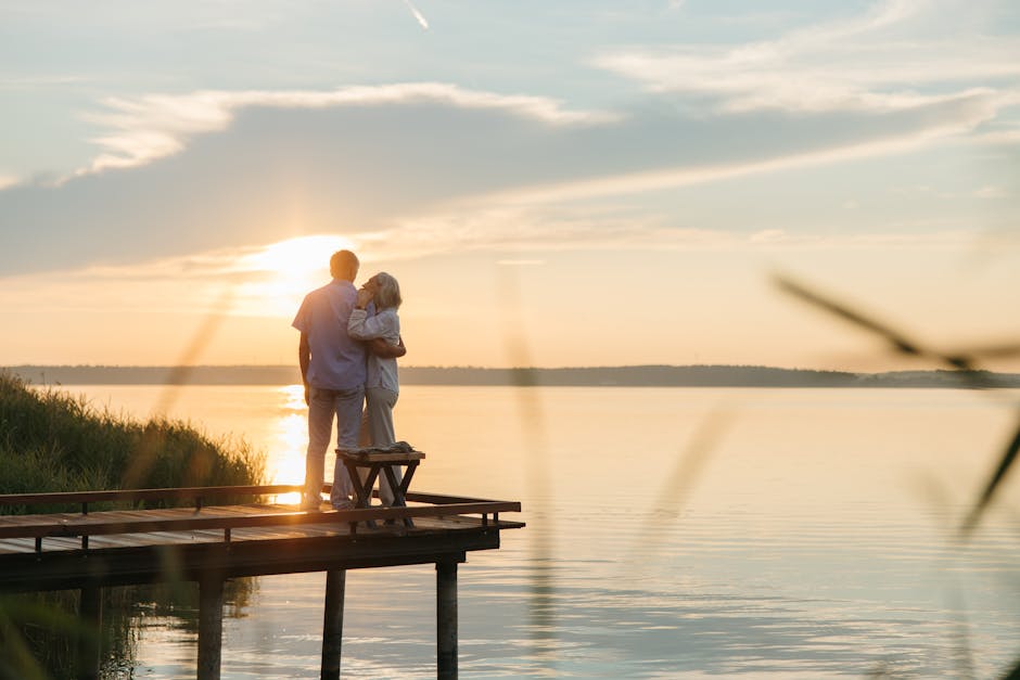 Couple watching sunset on lakeside promenade
