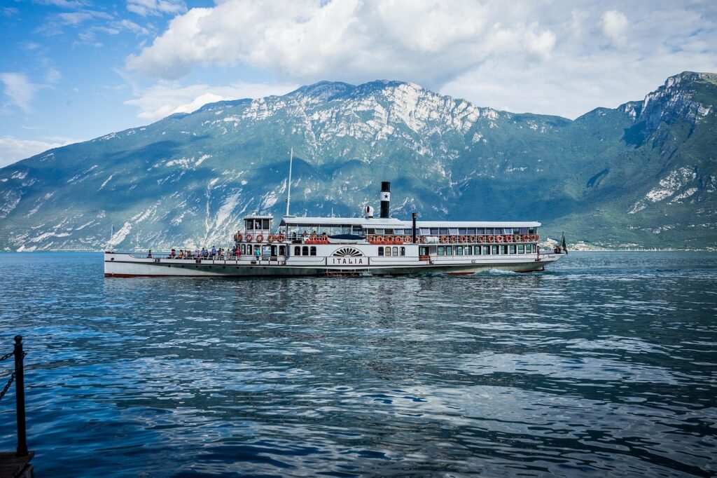 Vintage paddle steamer cruising on Lac de Garde with mountain backdrop