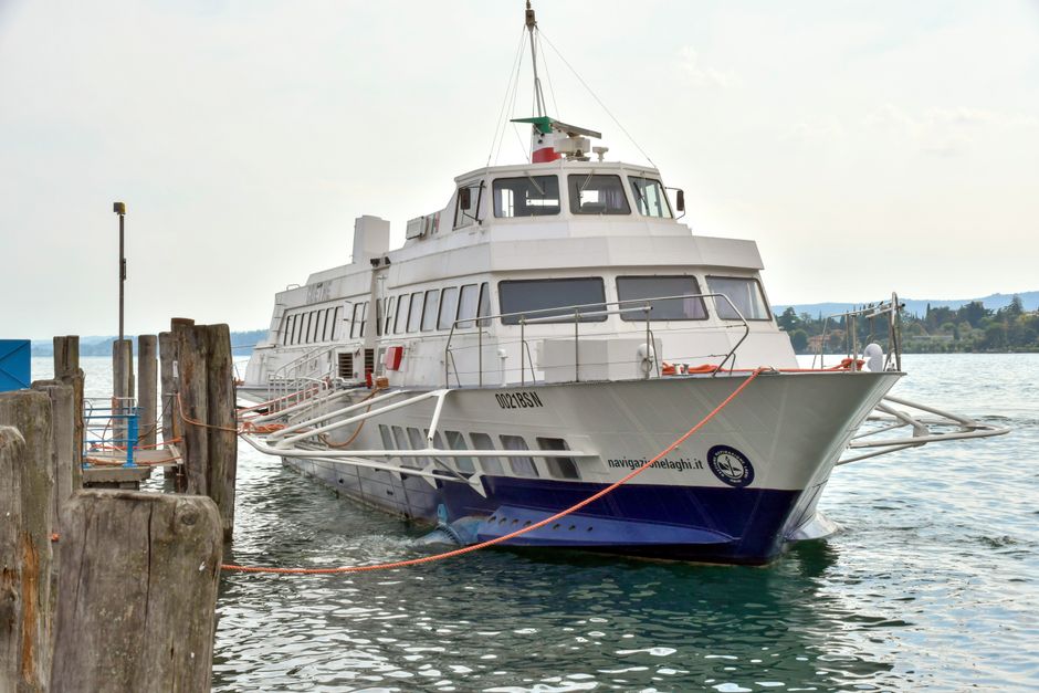 White passenger ferry moored at a Lac de Garde dock