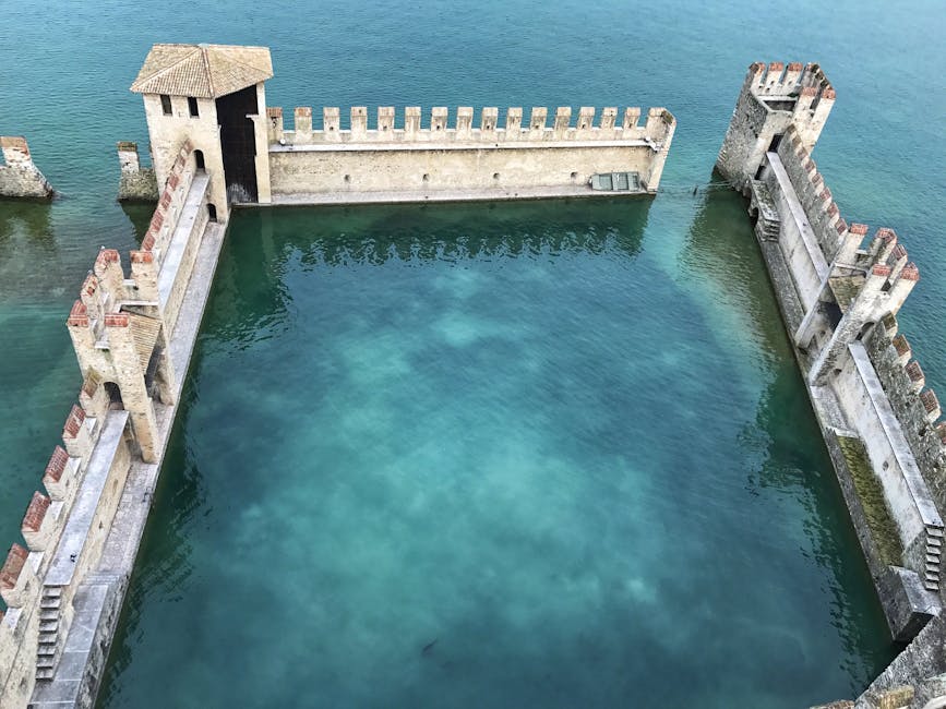 Aerial view of Lake Garda's turquoise courtyard inside medieval castle walls