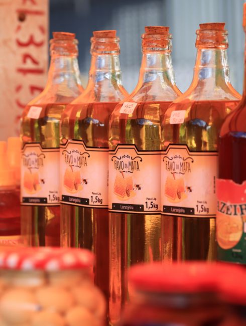 Rows of bottled olive oil and preserves at a Lac de Garde stall