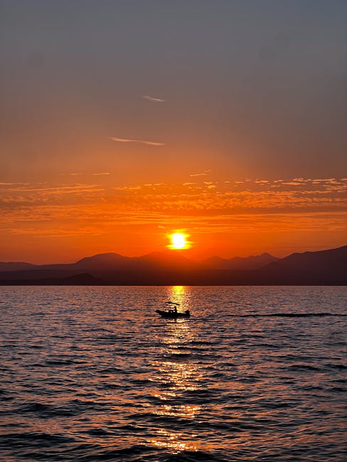 Small private boat on Lake Garda at sunset