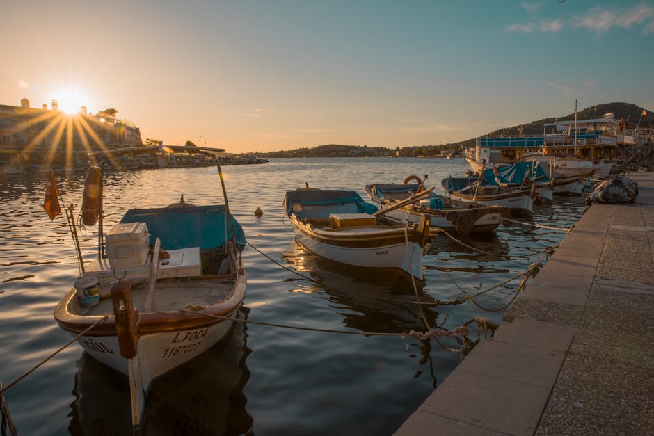 Barche tradizionali ormeggiate al tramonto nel porto della Sardegna