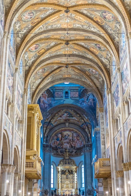 Ornate frescoed nave and altar inside Parma cathedral's vaulted interior