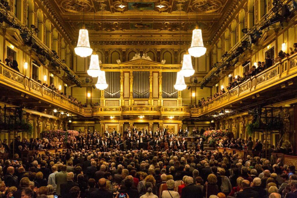 Packed golden concert hall with orchestra performing at Parma's theatre