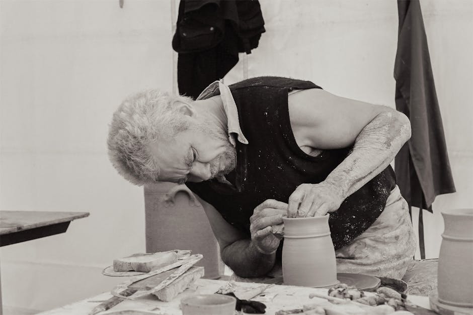 Artisan potter shaping a clay vase at a Parma craft fair