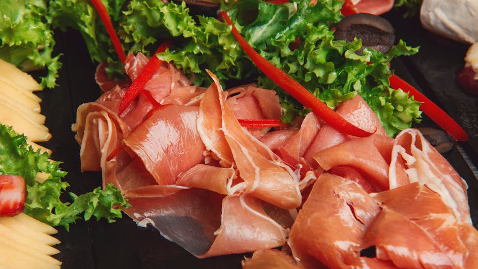 Thinly sliced Prosciutto di Parma arranged with salad greens