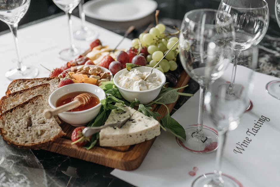 Wine tasting board with cheese, bread, grapes and glasses in Parma