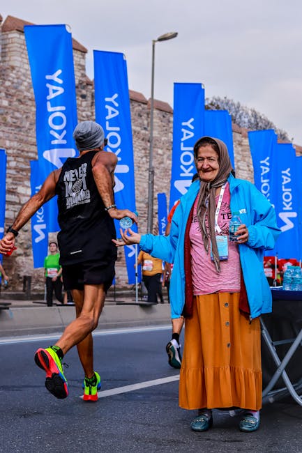 Bénévole distribuant de l'eau aux coureurs du marathon de Parme souriante