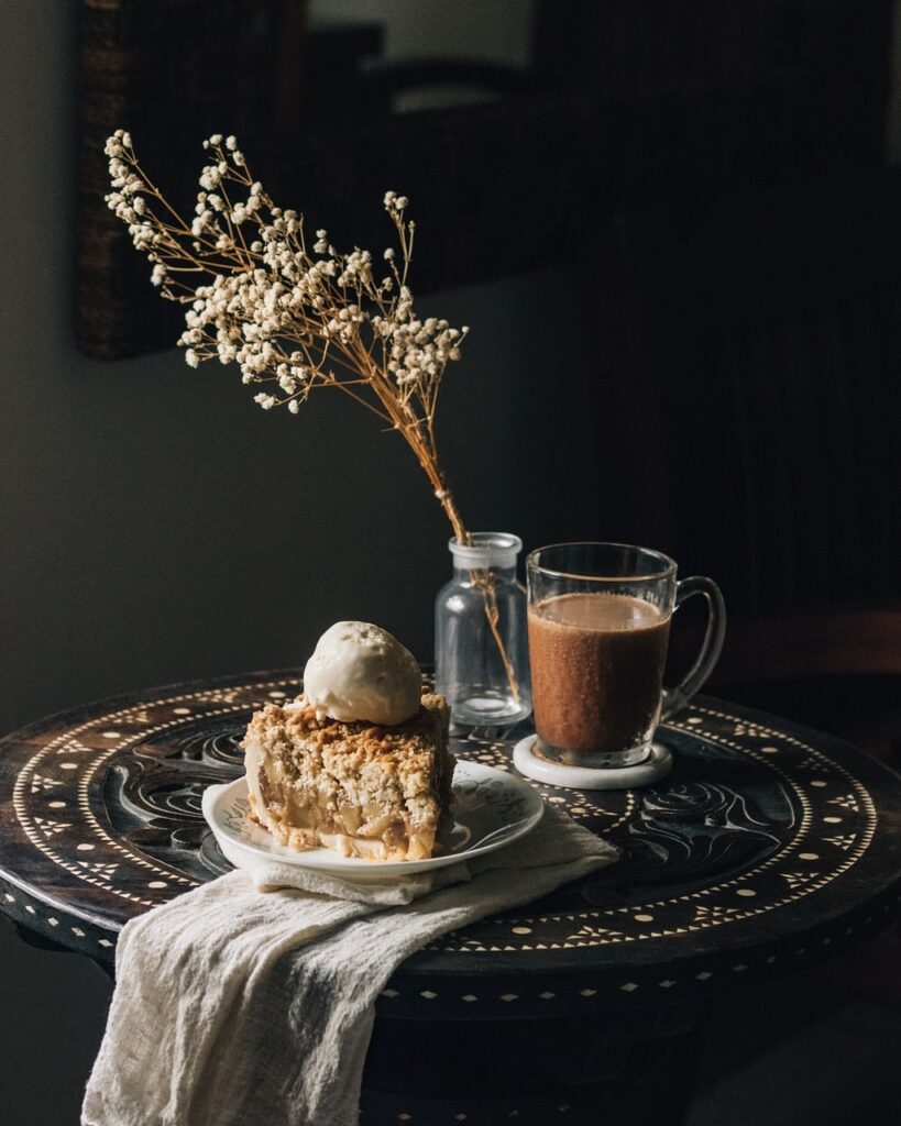 Rustic dessert slice topped with ice cream and espresso on table