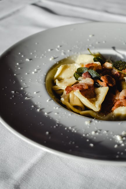 Plated tortelli with sage and crispy pancetta in a Parma trattoria