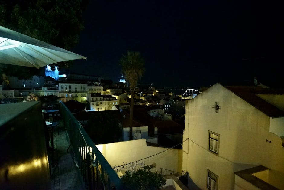 Couple dining rooftop Lisbon night view