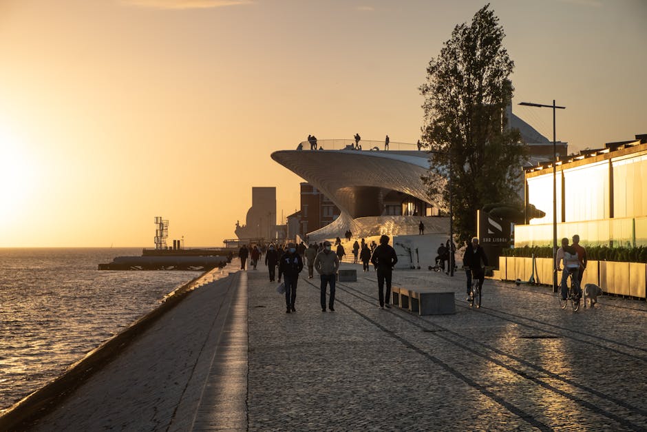 Lisbon waterfront family strolling sunset