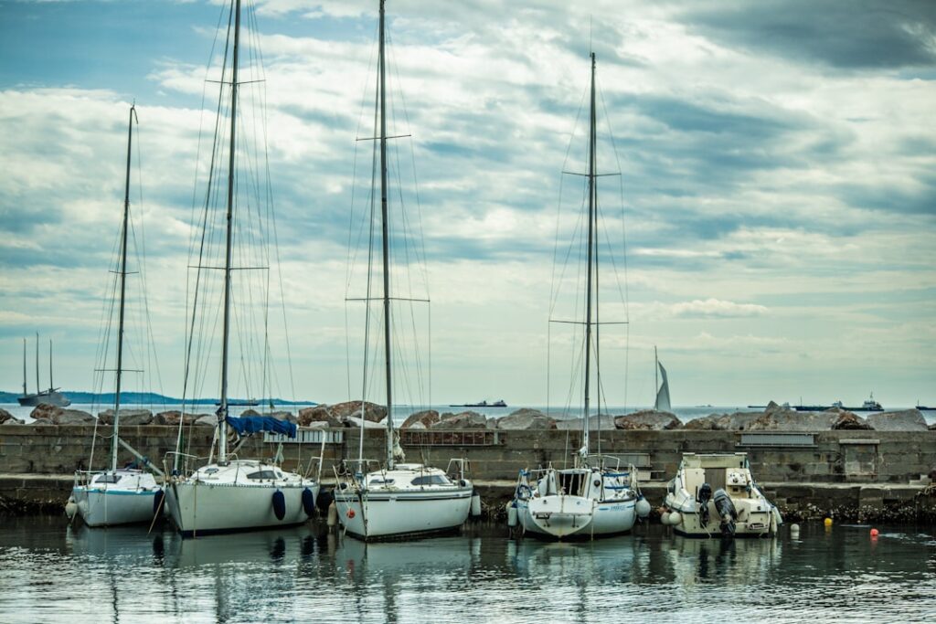Riva del Mandracchio waterfront with sailboats and cypresses