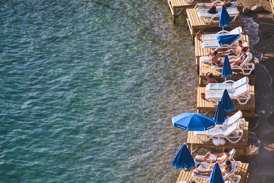 Seaside sun loungers on wooden platforms at a Trieste cove