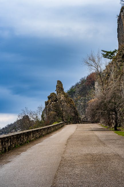 Karst plateau walking path with low scrub and distant vineyards