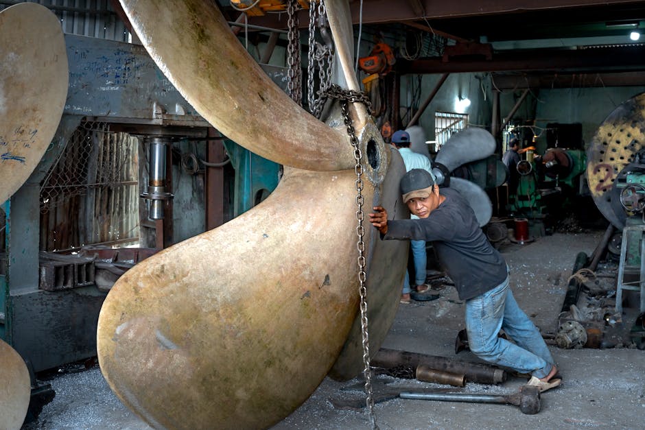 Mechanic installing a ship propeller at Officine Meccaniche Marittime workshop