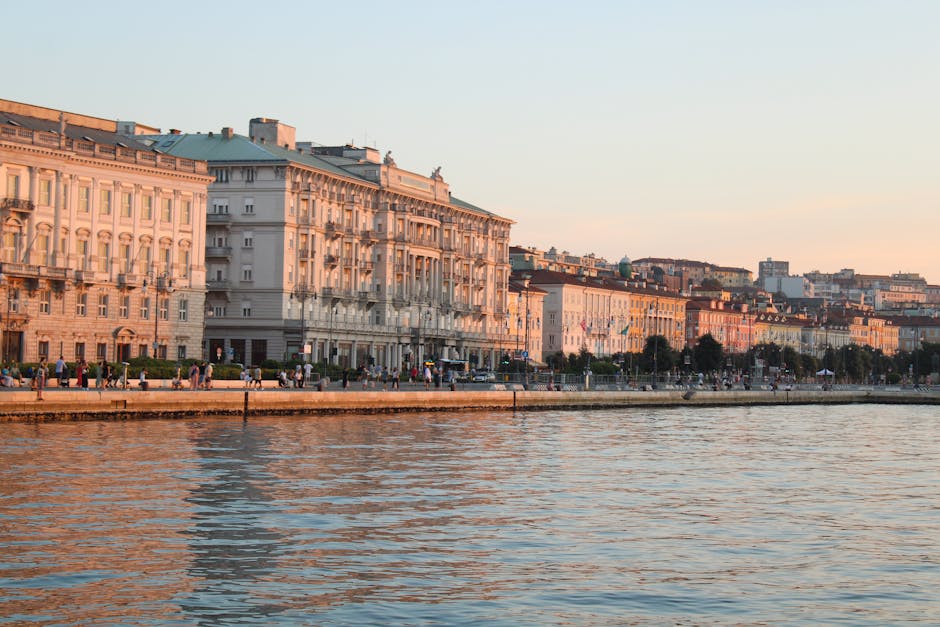 Sunset over the sea and historic buildings in Trieste