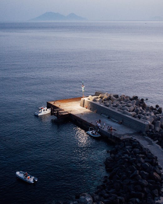 Small illuminated jetty and boats at dusk on the Aeolian Islands