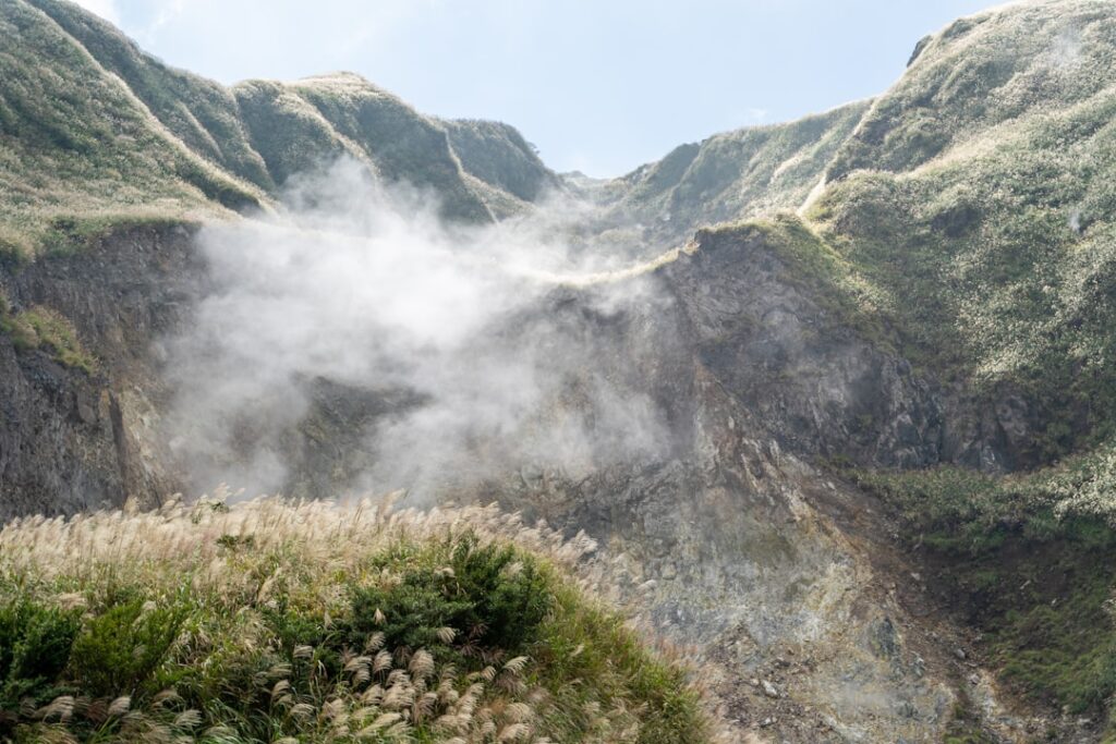 Steam rising from a grassy volcanic crater on the Aeolian Islands