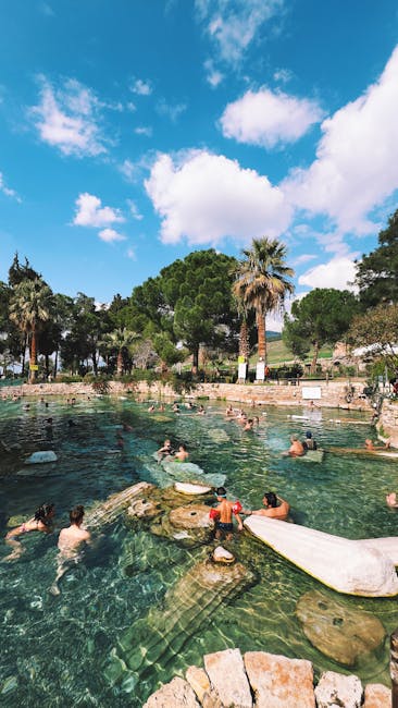 Natural thermal pool with swimmers and palm trees in Îles Éoliennes