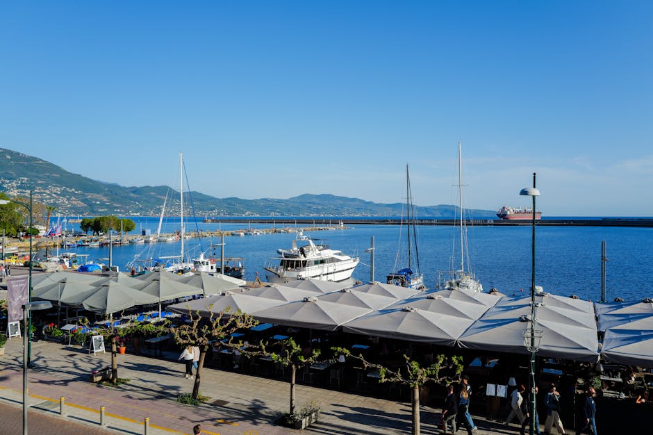Seaside marina with rows of umbrellas and moored yachts in the Aeolian Islands