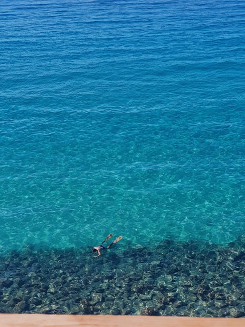 Solo snorkeler floating over crystal-clear seabed off Îles Éoliennes