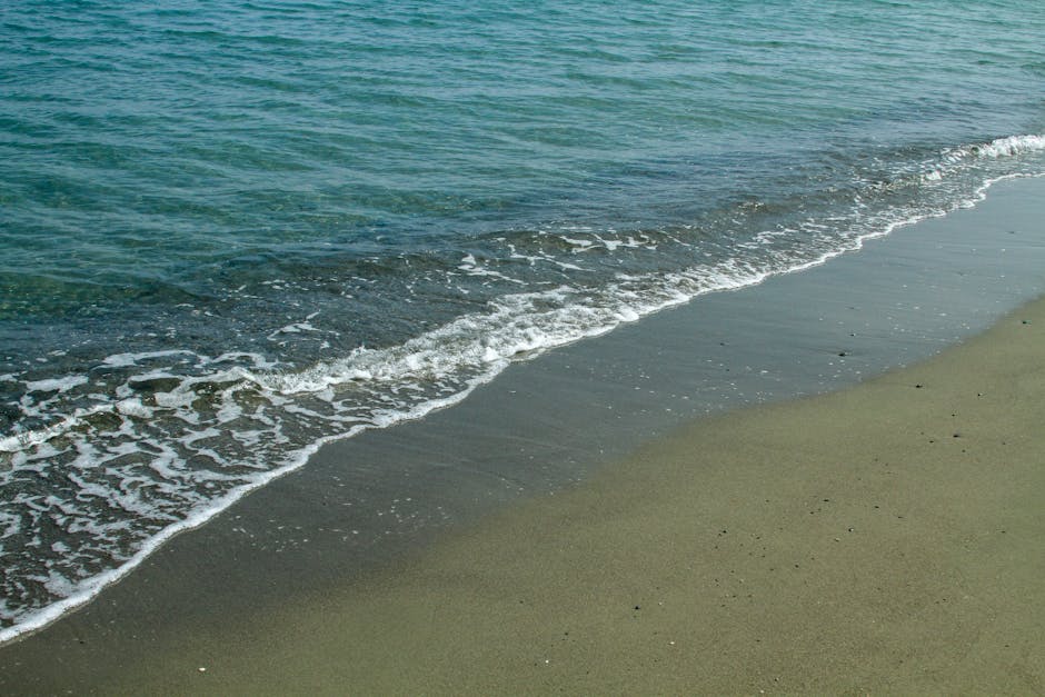 Gentle waves lapping dark sandy shore on a Îles Éoliennes beach
