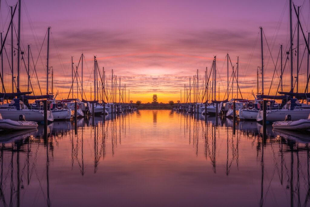 Sunset over Marina Corta with boats silhouetted