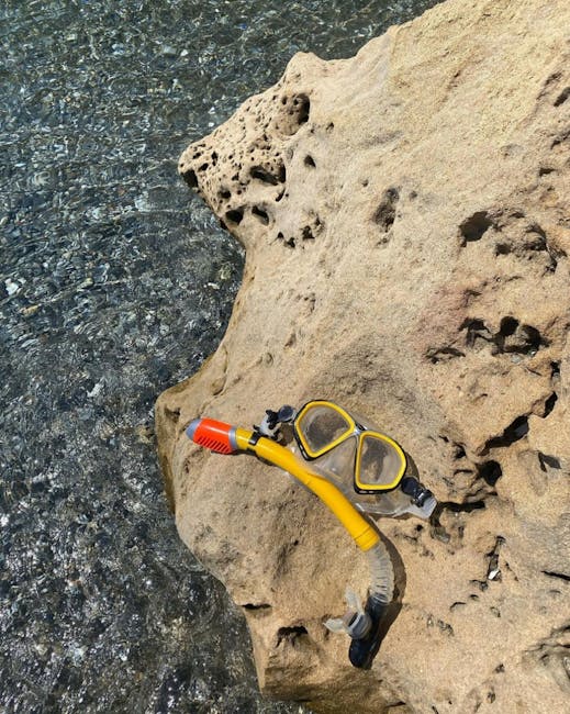 Yellow snorkel and mask resting on a porous rock at Îles Éoliennes