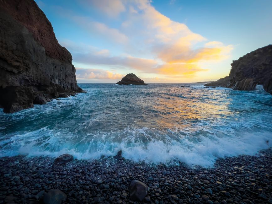 Waves breaking on a pebble cove at sunset in Îles Éoliennes