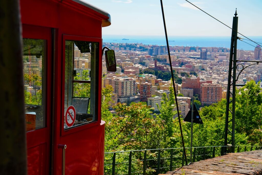 Historic tram passing through Genoa's city centre at midday