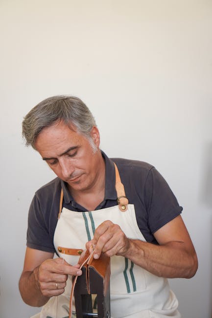 Leather artisan hand-stitching a shoe in a Modena workshop