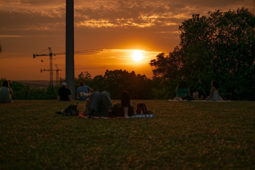 Couples on a Modena hill watching the golden sunset together