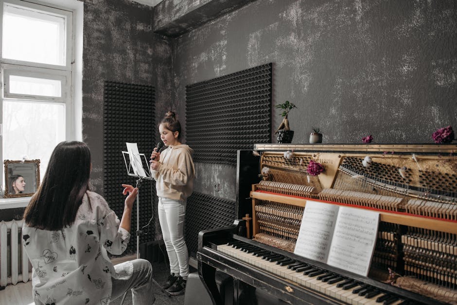 Young singer practicing with teacher beside open piano in Modena studio