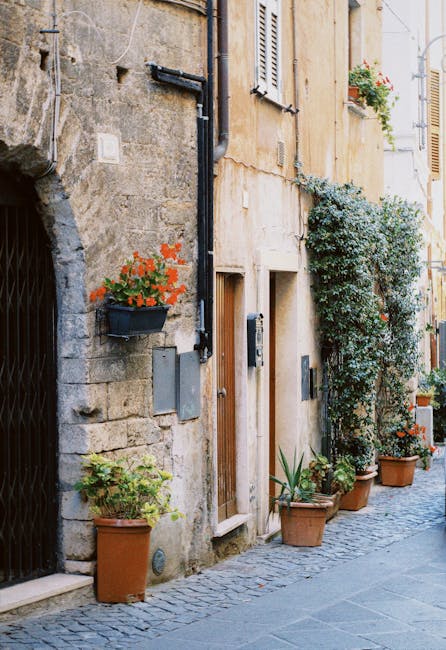 Cobblestone Capri alley lined with terracotta pots and plants