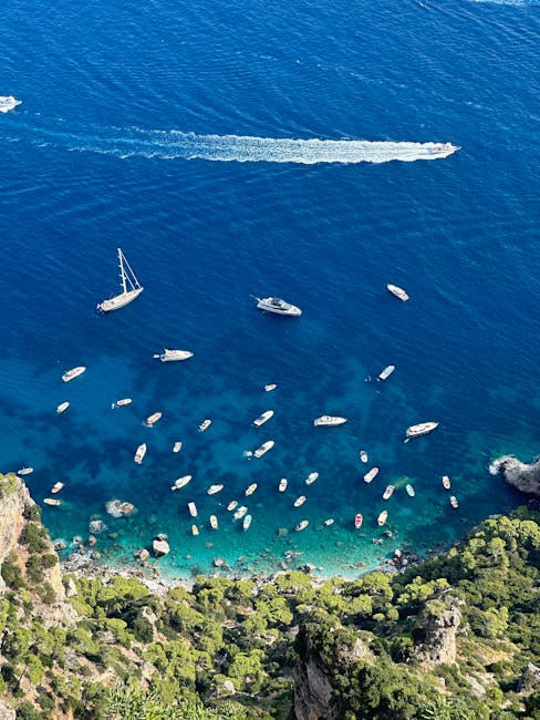 Aerial view of Capri coastline with many boats in turquoise sea