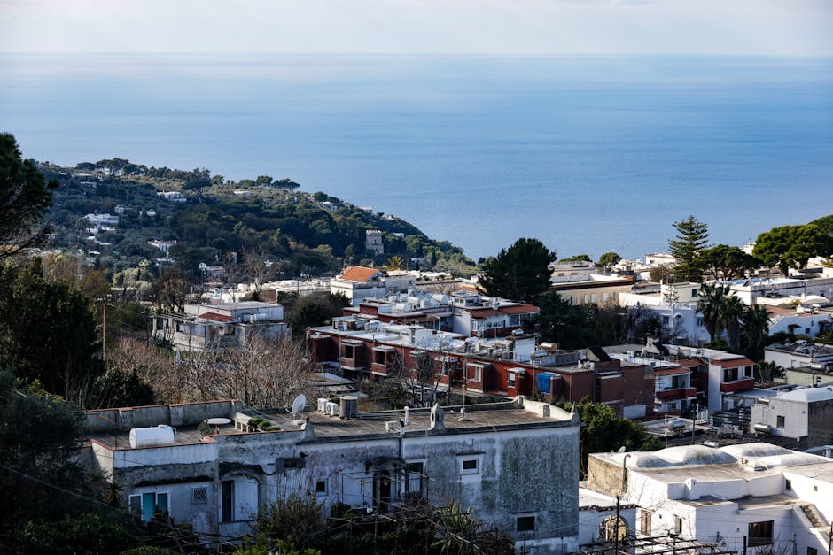 Roofs and villas on Capri hillside overlooking the calm Mediterranean Sea