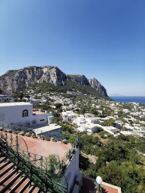 Capri hillside view with white houses, terraces and rocky cliffs