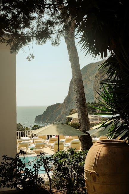 Seaside hotel pool terrace with umbrellas and sea view in Capri