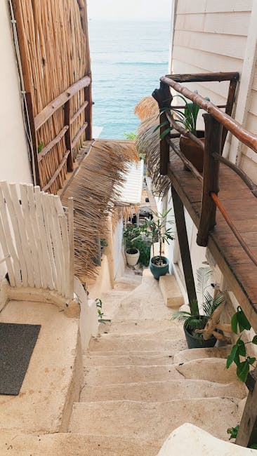 Stone steps leading down to a secluded waterfront entrance in Capri