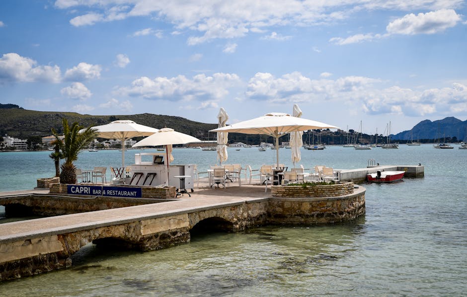 Seaside Capri bar terrace on a stone pier with umbrellas