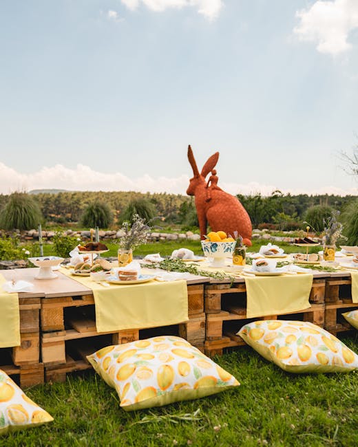 Low outdoor lemon-themed table setting with cushions and rabbit topiary