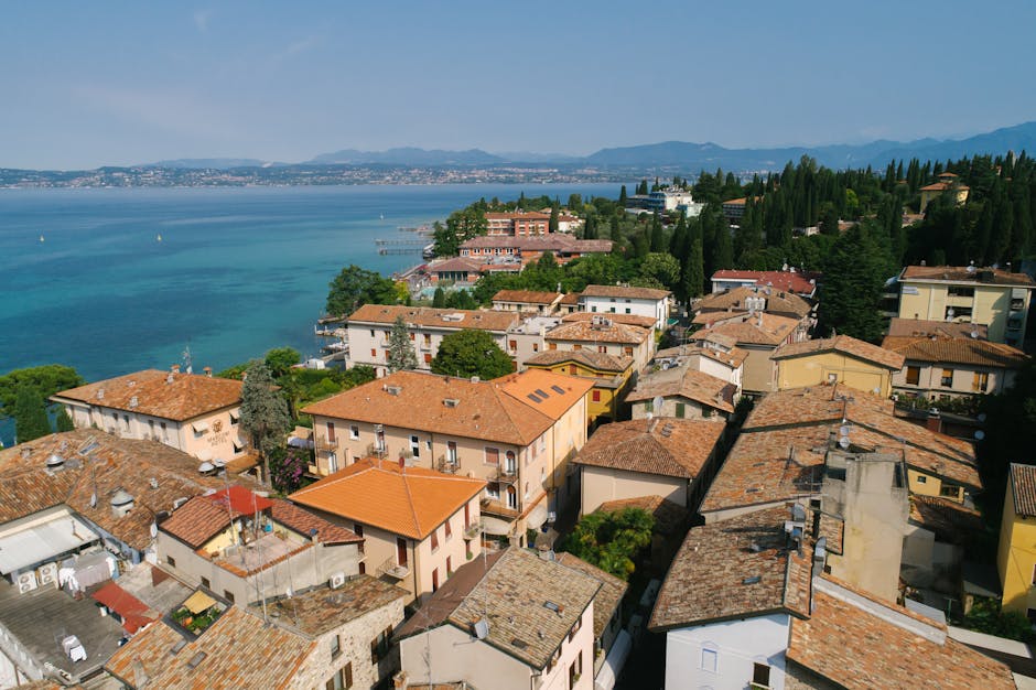 Aerial view of terracotta rooftops and blue sea along Capri coastline