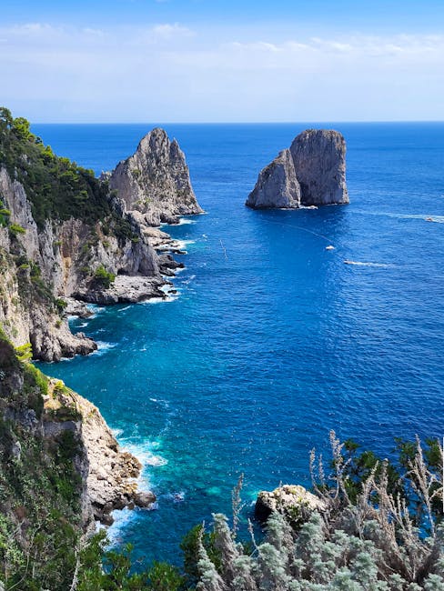 Clear turquoise waters and Faraglioni rock formations off Capri