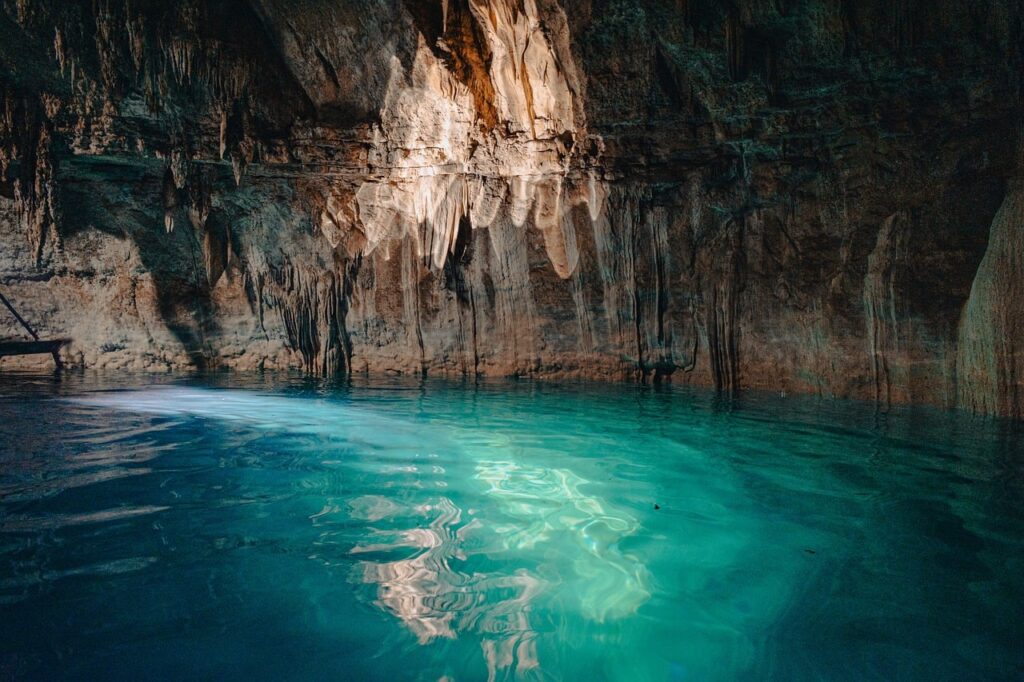 Sunlit turquoise pool reflecting cave walls inside Capri's Blue Grotto